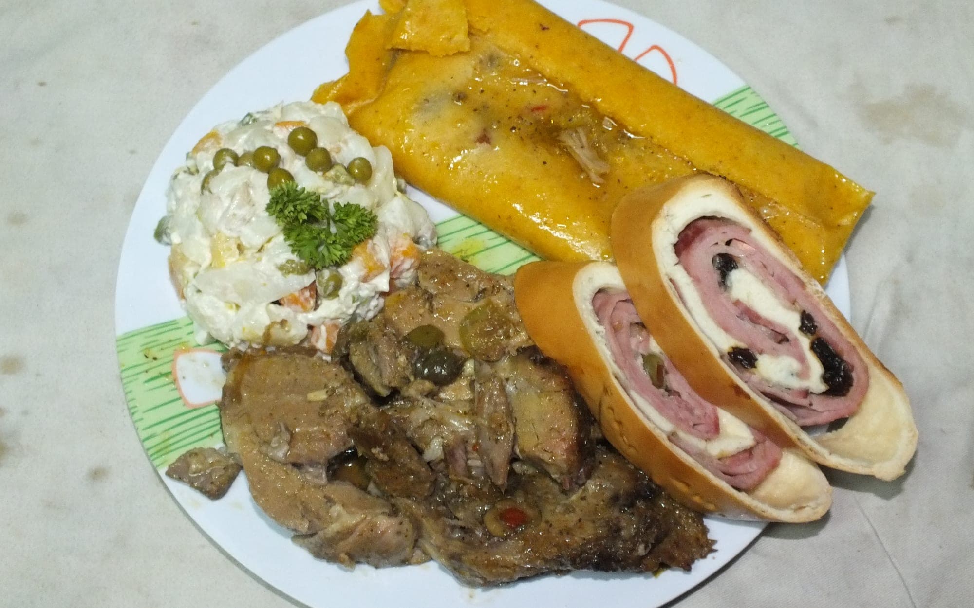 Plato navideño venezolano con hallaca, pan de jamón, ensalada de gallina y pernil